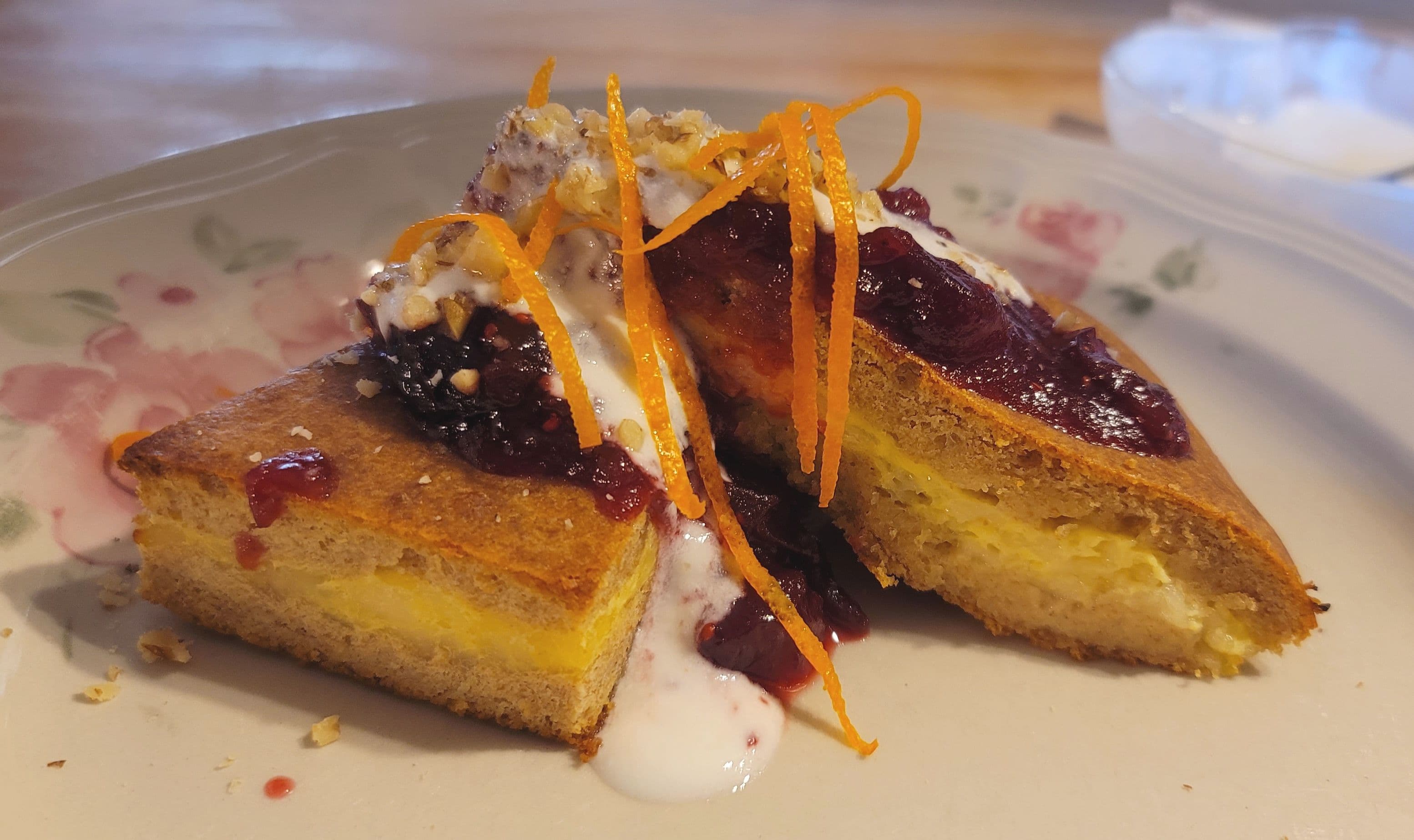 French baked pancake with custard center, berry topping, cream drizzle, and orange zest at Whispering Pines Bed and Breakfast French baked pancake with custard center, berry topping, cream drizzle, and orange zest at Whispering Pines Bed and Breakfast
